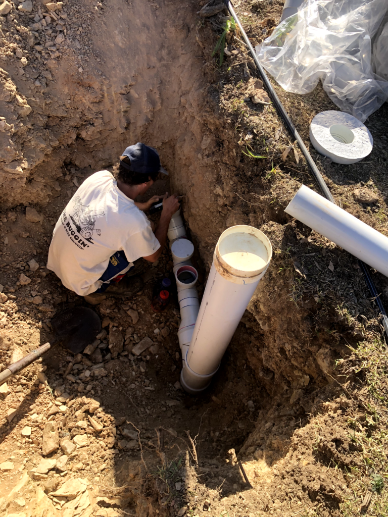 man fixing pipes